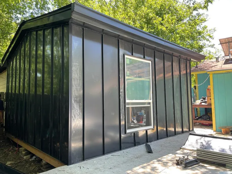 Black standing seam metal wall panels for Roof Inspection in St. Helens